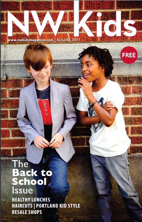 2 boys standing in front of brick wall