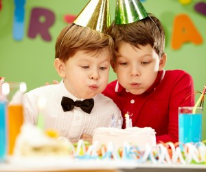 boys blowing out birthday candles