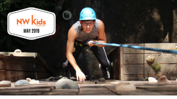 young adult climbing rock wall